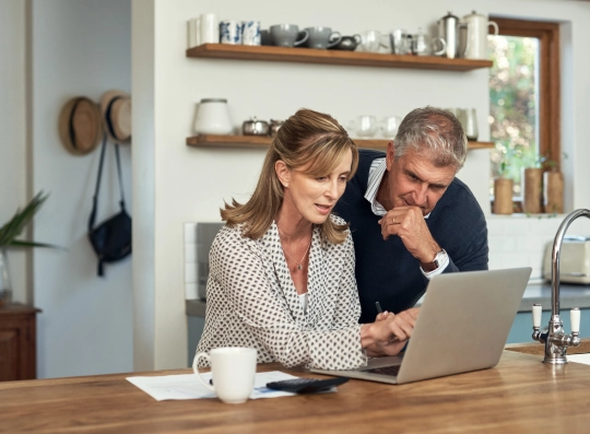 image of potential Signature Window clients in their living room looking at computer